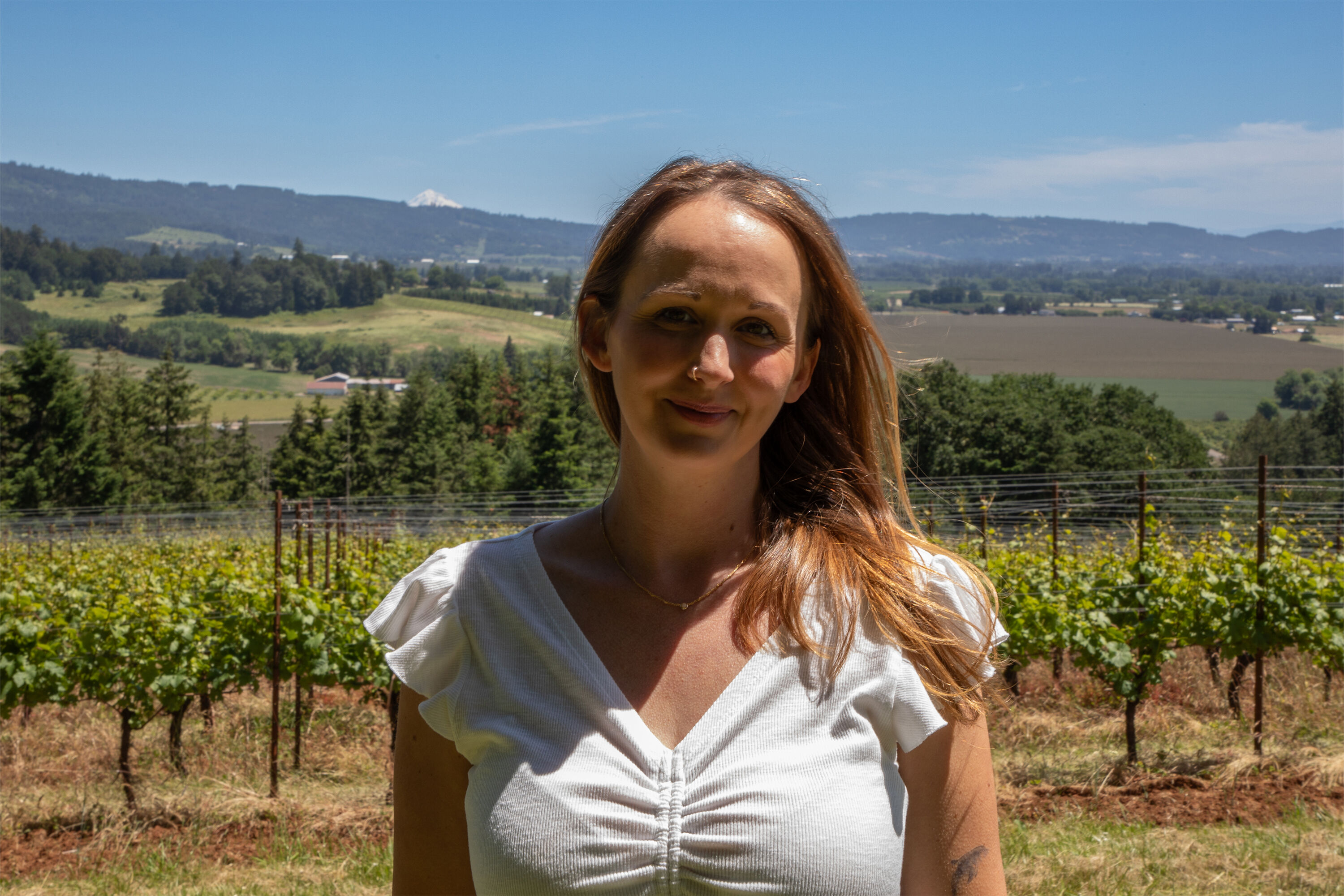 Jessica Burkhart in front of Penner-Ash estate vineyard